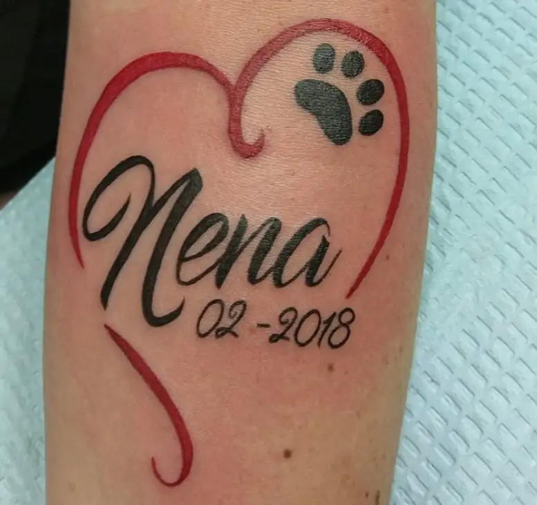 heart line tattoo with name, black paw print and date tattoo on forearm