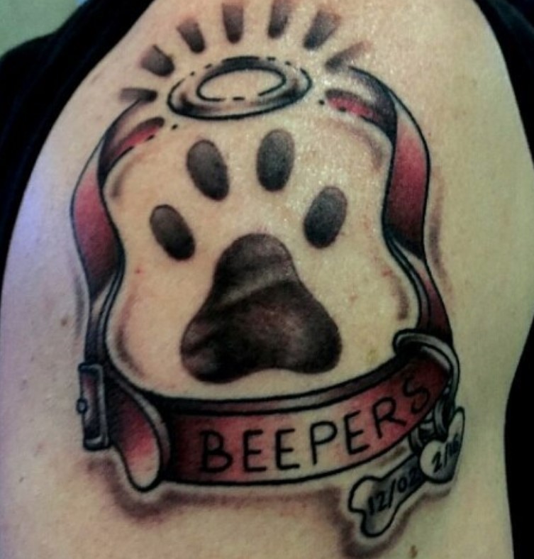 red dog collar with name and paw print inside with halo on top of it tattoo