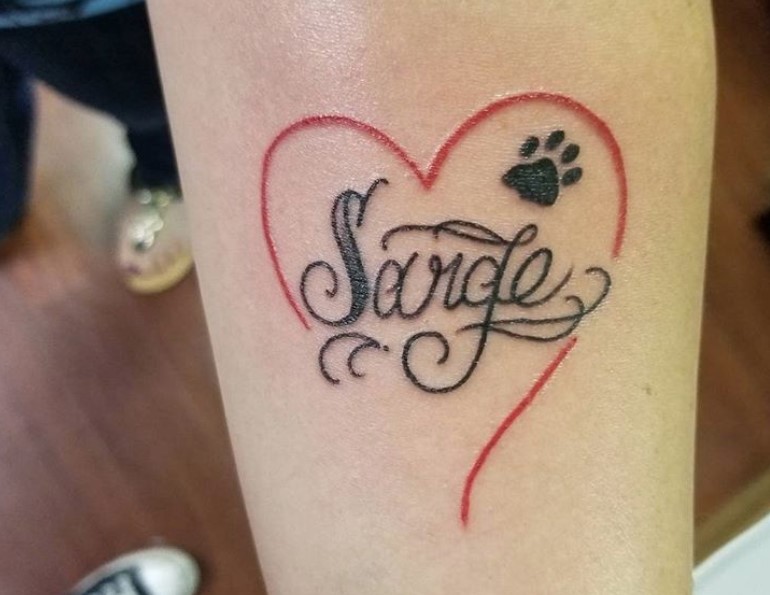 heart line with name and paw print tattoo on forearm