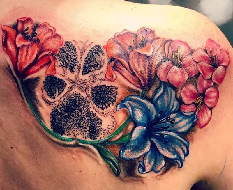 paw print with colorful flowers tattoo on the back