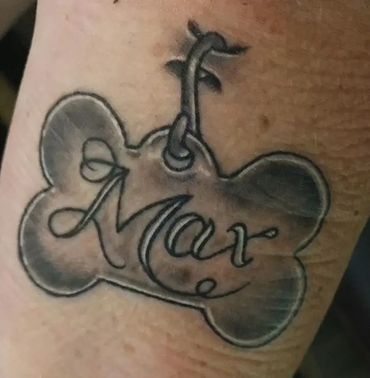 3D tattoo of bone shaped tag with name 