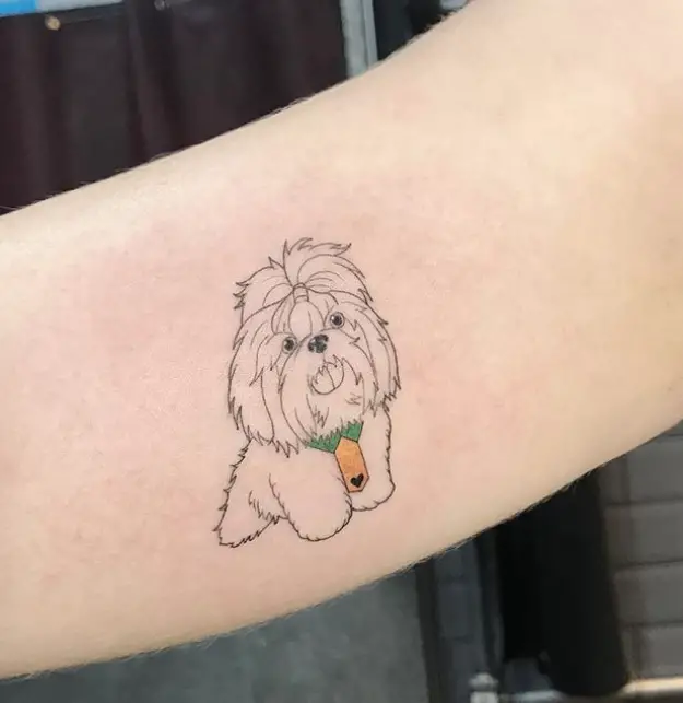 outline of a sitting Shih Tzu wearing a green collar with yellow necktie tattoo on the biceps