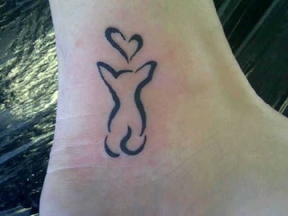 back of a sitting dog with a heart shaped outline tattoo on the ankle