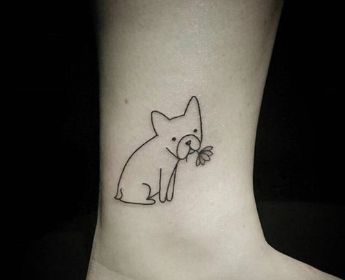 outline of a small dog sitting with a flower in its mouth tattoo on the ankle