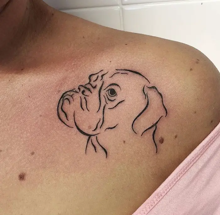 outline sideview face of a Boxer dog tattoo on the shoulder of a woman