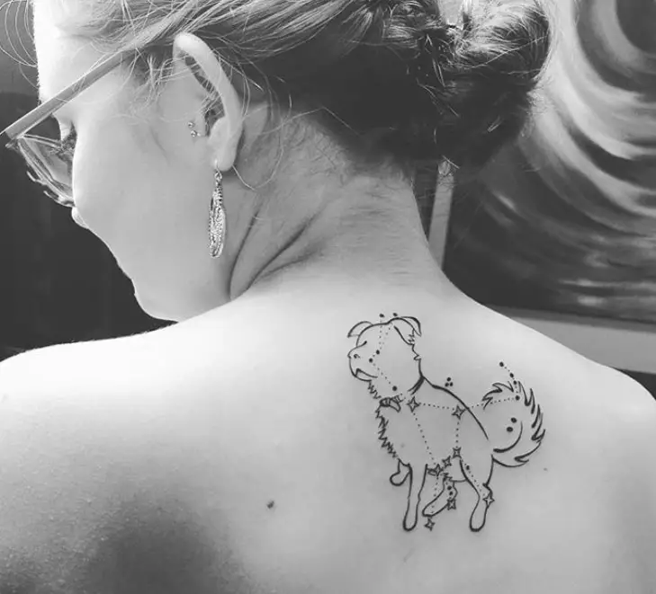 Outline of a Border Collie with the constellations tattoo on the back of a woman