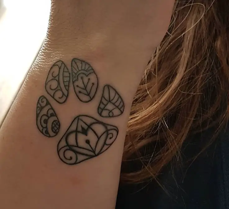 mandala design in paw print tattoo on wirst