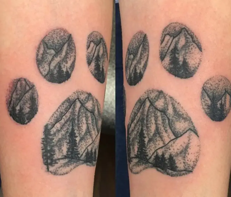 mountain inside a paw print tattoo