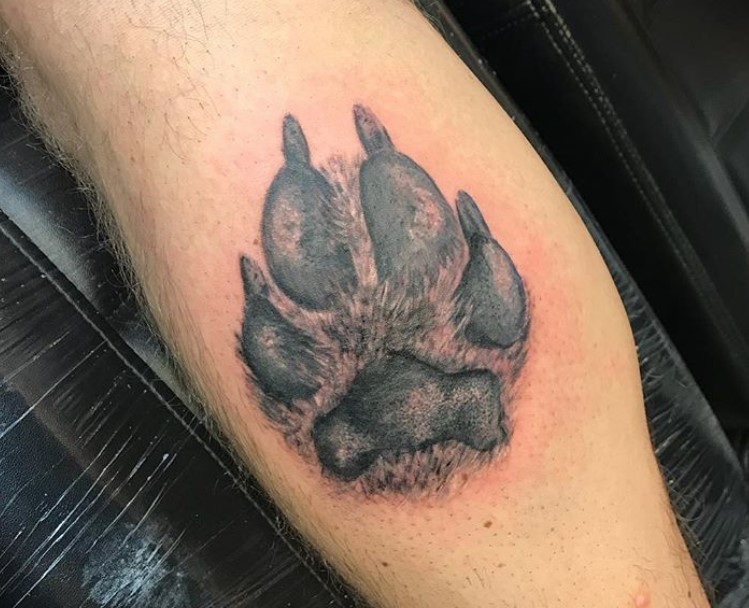 3D paw print tattoo on the leg