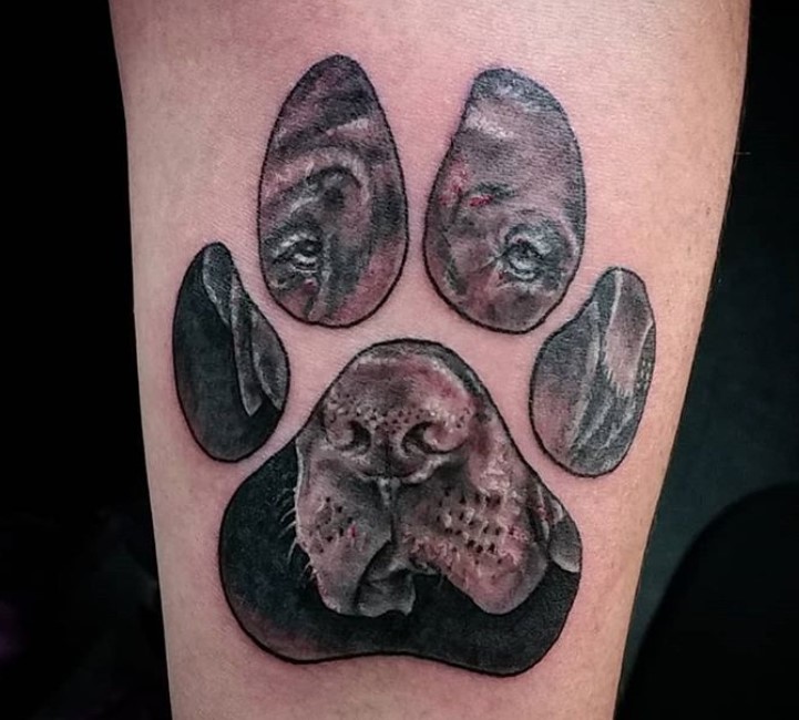 face of dog in paw print tattoo