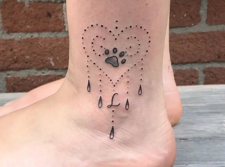 dotted heart shaped with paw inside tattoo on the ankle