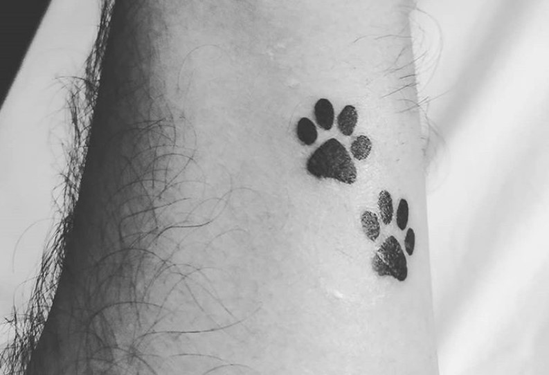 paw prints tattoo on wrist