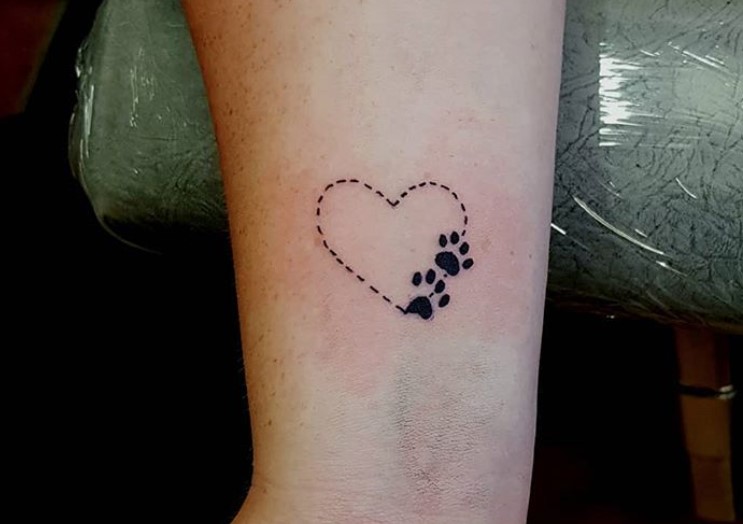 Dotted heart with paw print tattoo on wrist