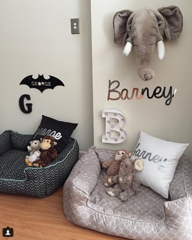 dog bed with stuffed toys and pillows