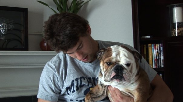 Michael Phelps with his English Bulldog in his arms