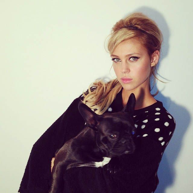 Nicola Peltz holding her black French Bulldog