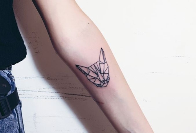 A minimalist Geometric face of a Cat Tattoo on the forearm