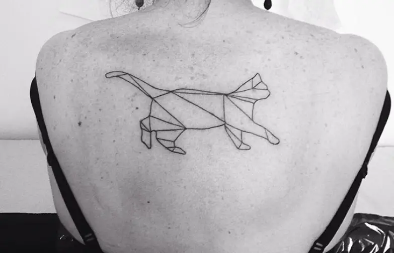A walking geometric cat tattoo on the back of a woman