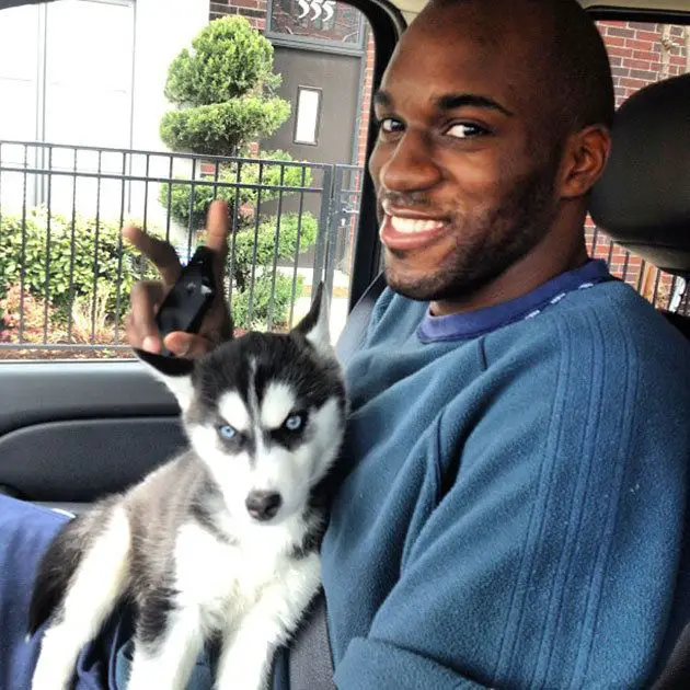 Quincy Pondexter inside the car with his Siberian Husky puppy on his lap
