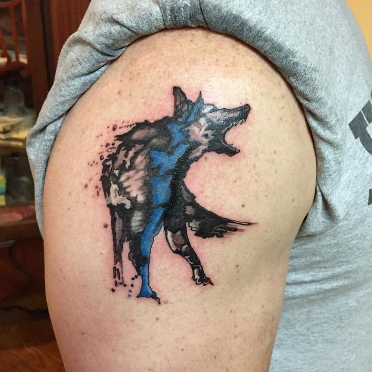 artistic aggressive German Shepherd dog tattoo on the shoulder