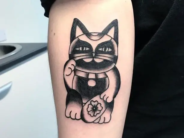 A black and gray Lucky Cat Tattoo on the forearm