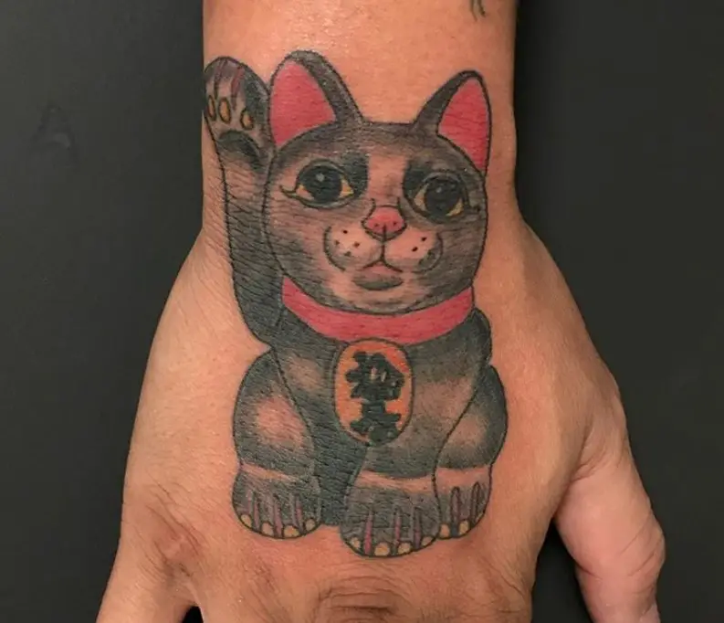 A black and gray Lucky Cat Tattoo on the hand