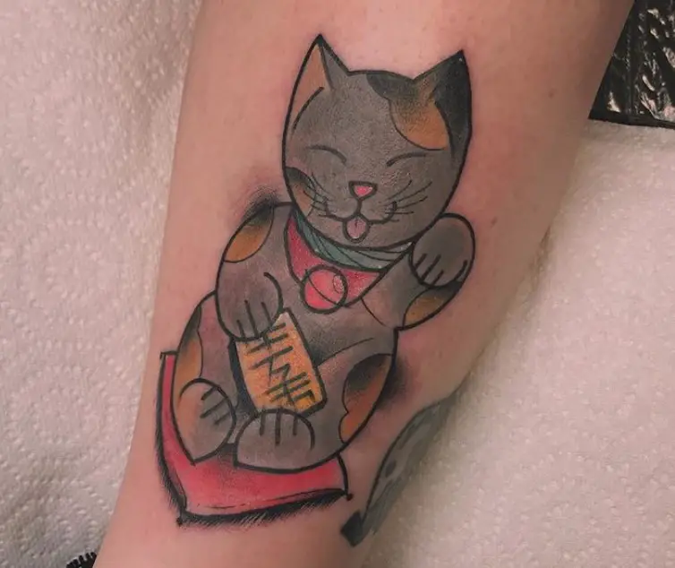 A gray with brown spots Lucky Cat Tattoo on the leg