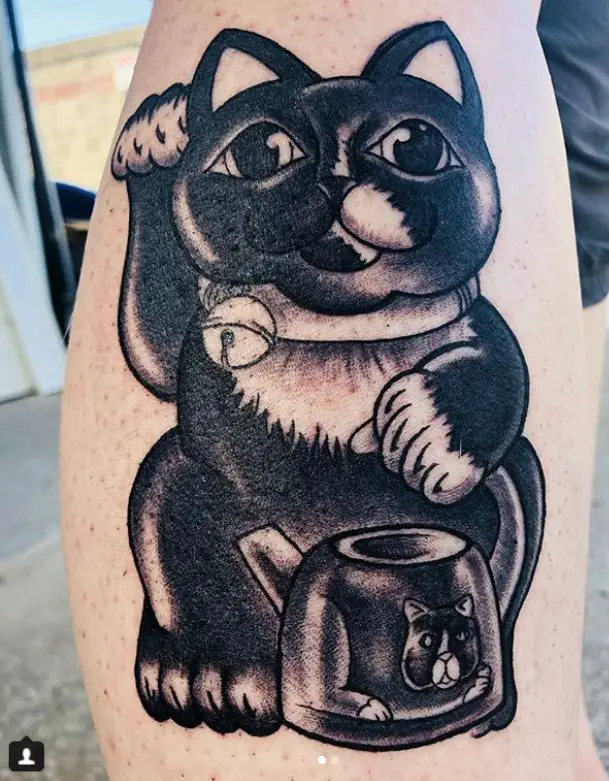 A black and white Lucky Cat Tattoo on the leg