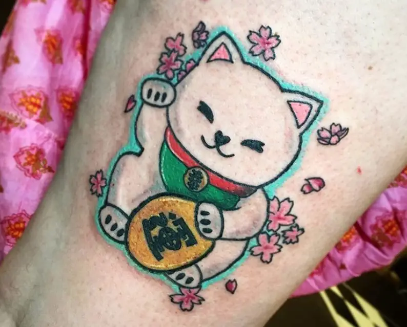 A Lucky Cat with sakura flowers tattoo on the thigh