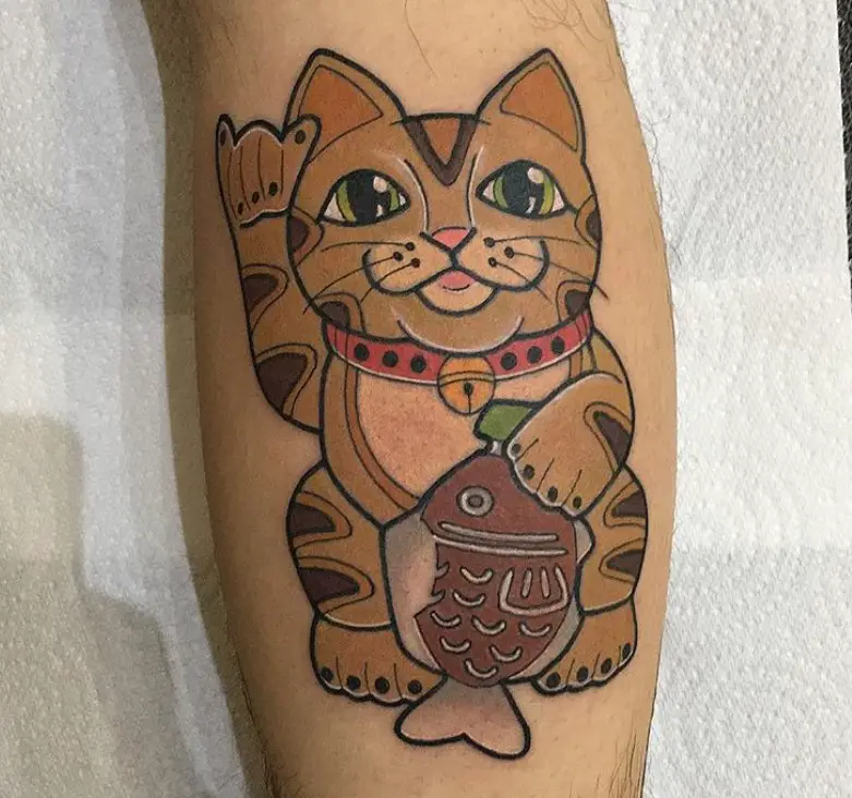 A brown Lucky Cat Tattoo on the leg