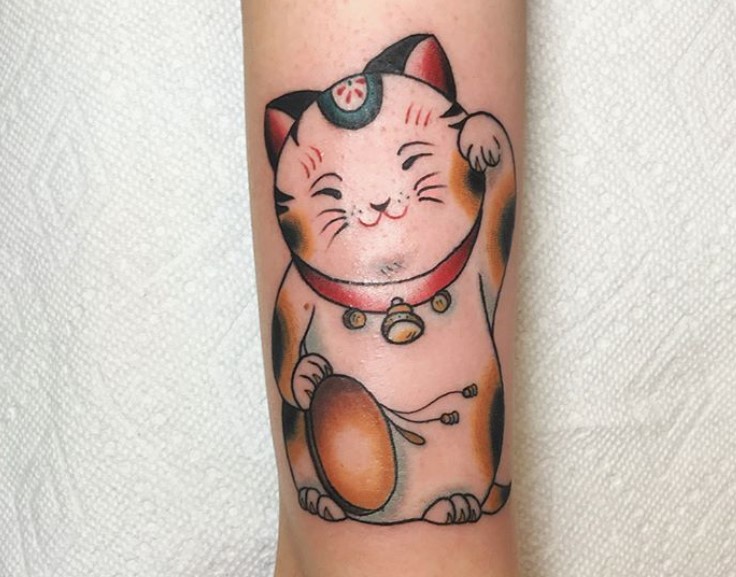 A Japanese Lucky Cat Tattoo on the leg
