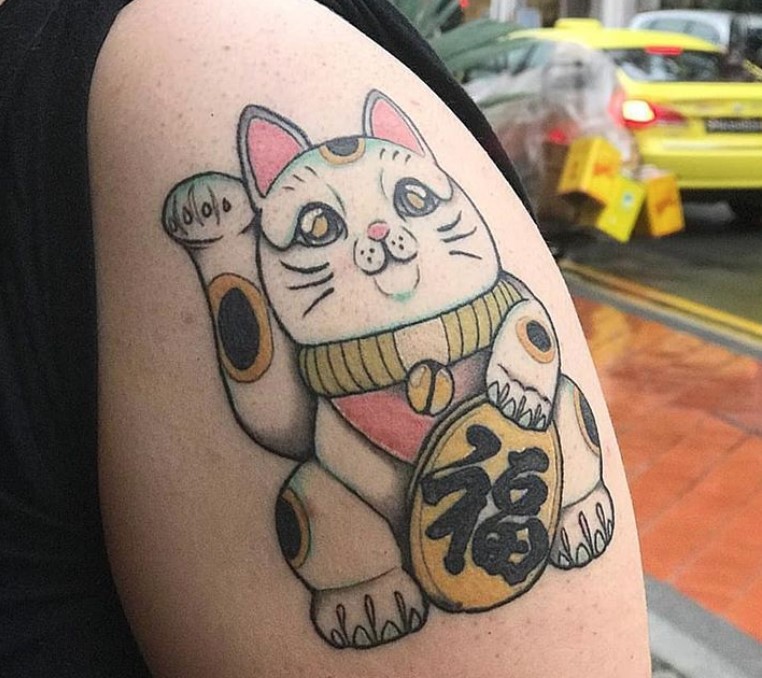 An adorable Lucky Cat Tattoo on the shoulder