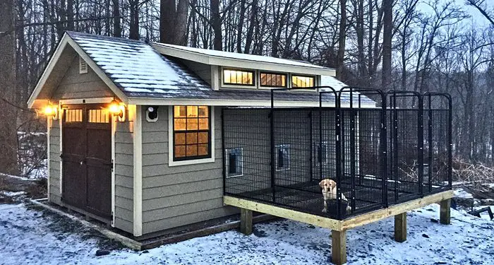 modern gray and black dog kennel house outdoors during night time in winter season