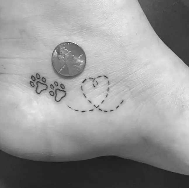 small dotted line heart and paw print tattoo on the heel