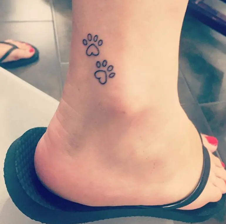 small outline paw prints tattoo on the ankle