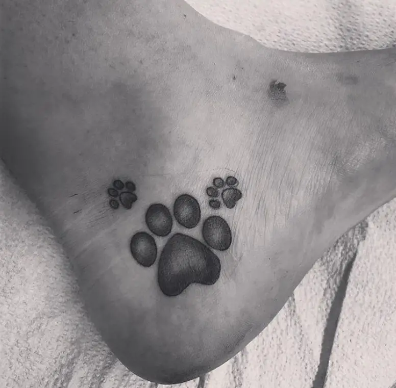 black paw print tattoo on the heel
