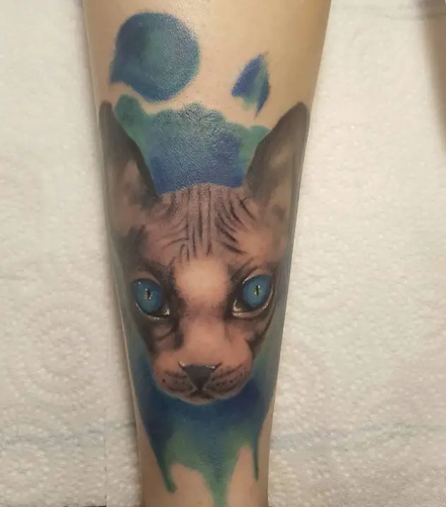 face of Realistic Cat with blue green watercolor splashes Tattoo on forearm