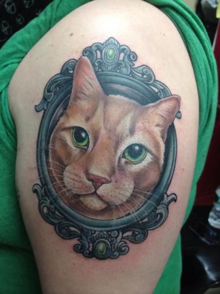 realistic face of cat inside a frame tattoo on shoulder