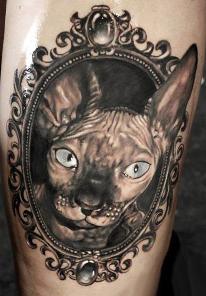 Realistic Cat inside a frame tattoo
