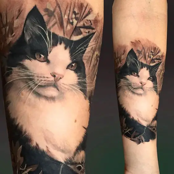 Realistic Cat with flowers and leaves around Tattoo on forearm