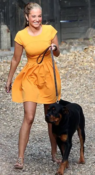 Tulisa Contostavlos walking with her Rottweiler