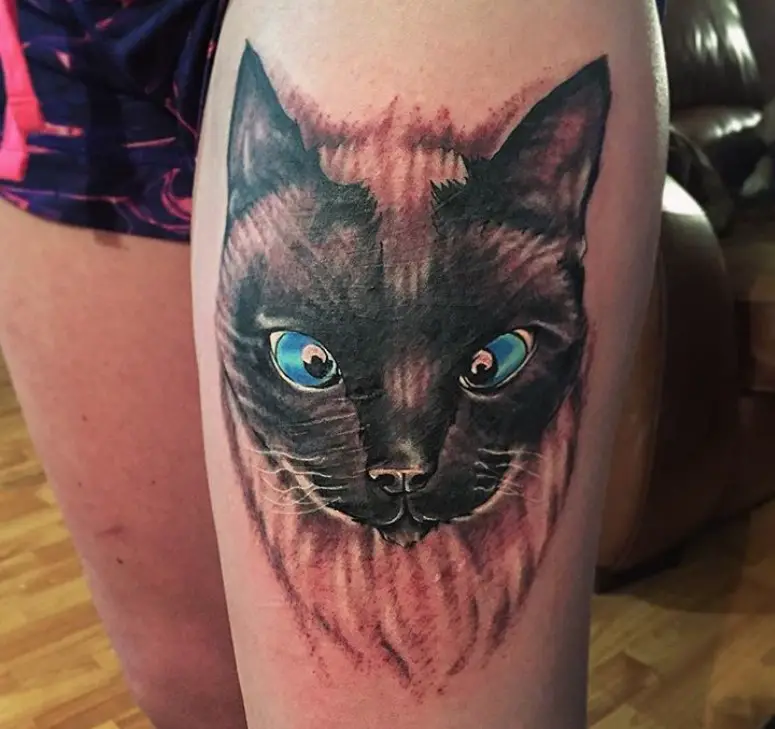 realistic face of a Siamese Cat tattoo on thigh