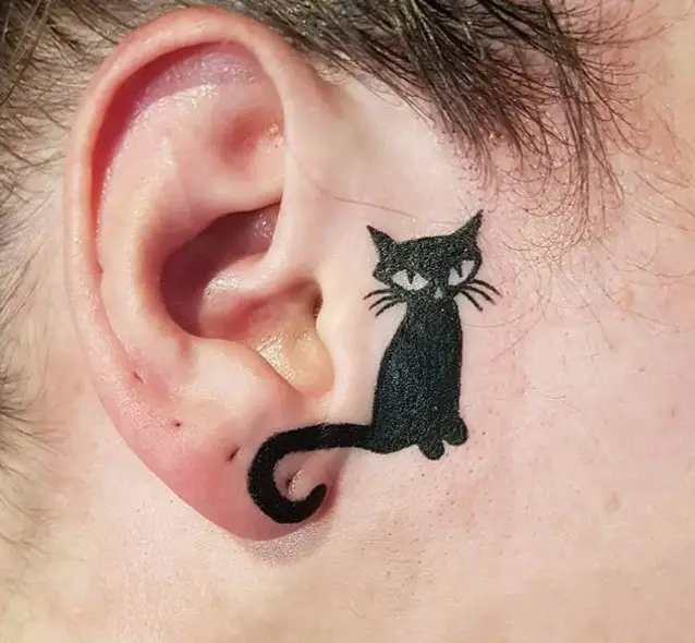 sleek black cat tattoo on the side of the ears