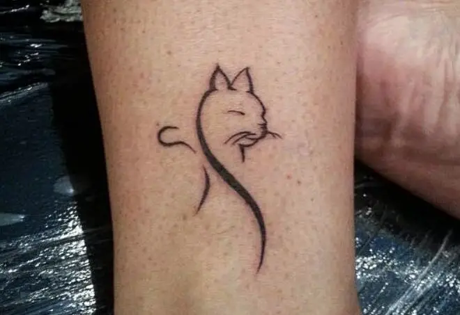 outline of cat tattoo on the ankle