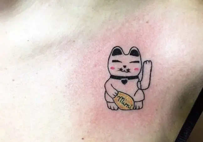 lucky cat tattoo on the ches
