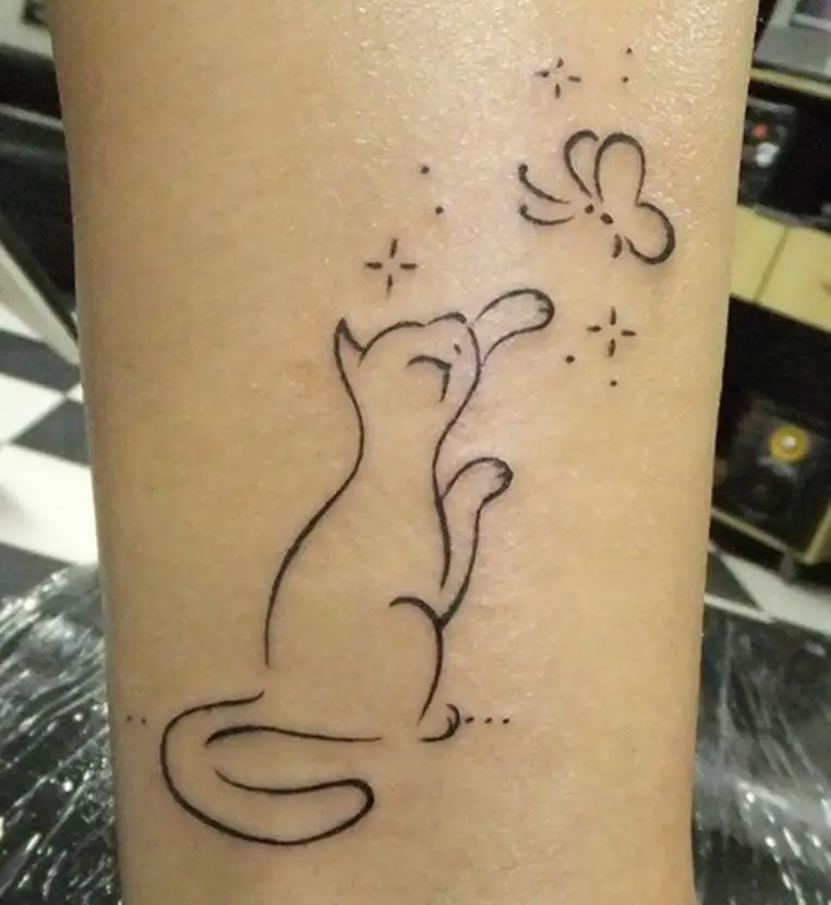 outline tattoo of a cat grabbing a butterfly