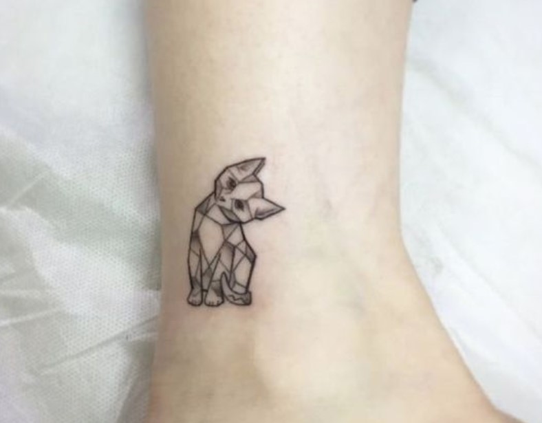 sitting cat tilting its head in geometric design tattoo on the ankle