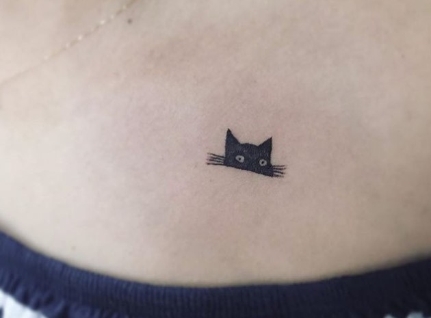 upper half face of a black cat tattoo