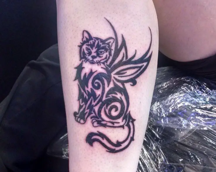 A Tribal Cat with wings Tattoo on the leg
