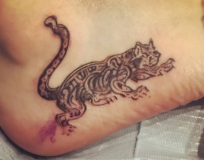 A scaryTribal Cat Tattoo on the heel